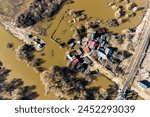 Heavy river flooding inundates the land in the countryside, aerial view