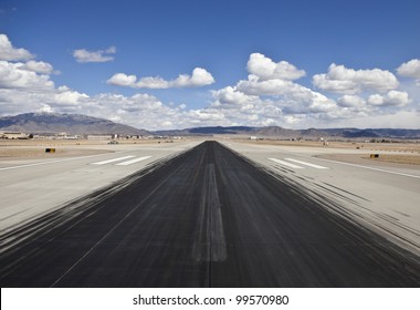 Heavy Skid Marks On A Busy North American Desert Airport Runway.