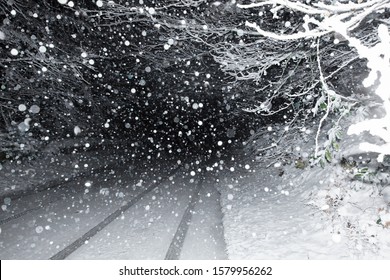 A heavy snow storm at night on the main highway between Gloucester and Painswick, near Painswick, The Cotswolds, Gloucestershire, UK