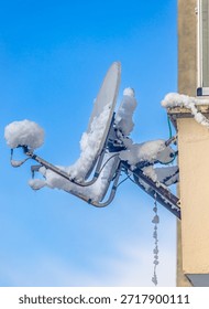Heavy snowfall eventually covered satellite dishes on houses with snow.