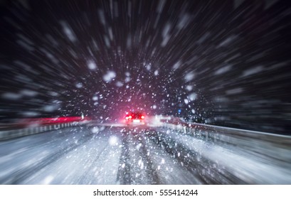 Heavy Snowfall Hinders Traffic On A Road At Night
