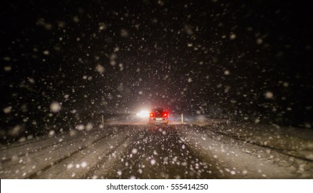 Heavy Snowfall Hinders Traffic On A Road At Night
