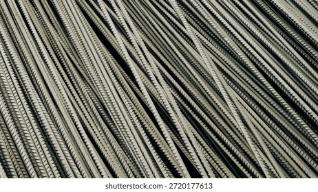 Heavy stack of 12mm ribbed bars. The image conveys the robustness required for structural engineering.