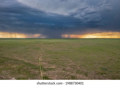 heavy storm cloud over green prairie and distant Rocky Mountains - Pawnee National Grassland in Colorado, aerial view of late spring or early summer scenery - Shutterstock ID 1988730401