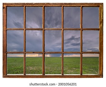 Heavy Storm Cloud Over Green Prairie In Late Spring Or Early Summer Scenery As Seen From Vintage Sash Window