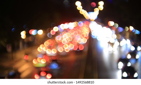 Heavy Traffic Congestion In The City. Car Headlights And Rear Lights Defocused. Road Light Bokeh. View From The Top , High Angle Perspective. Metropolis Problem Bad Quality Of Life.