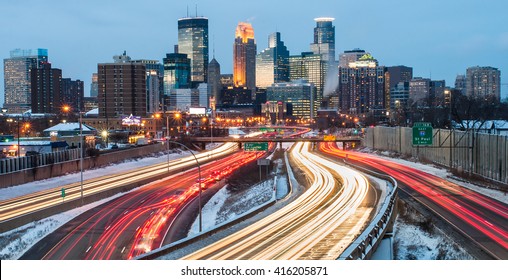 Heavy traffic flowing in and out of Minneapolis just after sunset, on a cold winter evening.