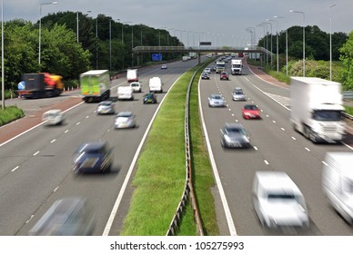 Heavy traffic moving at speed on the M6 motorway in England
