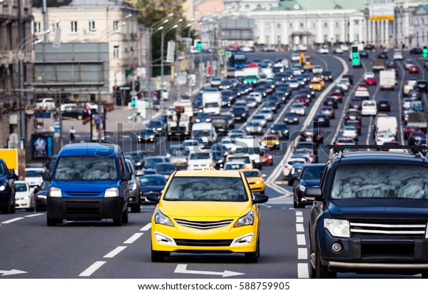 Heavy traffic on the city highway with yellow\
taxi car on the\
foreground