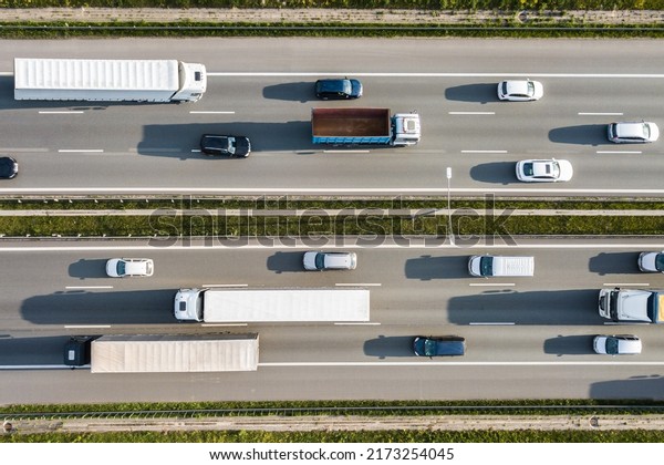 Heavy traffic on a highway, big freight\
trucks on a highway with motion blur\
effect