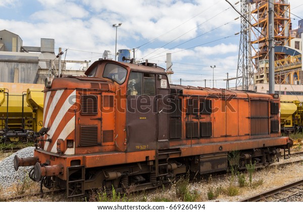 heavy train\
wagon with industrial building\
factory