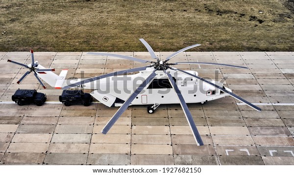 Heavy transport helicopter aerial view. loading\
equipment on the runway.