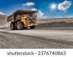 heavy truck , at the open pit diamond mine carry a kimberlite load uphill the dirt road