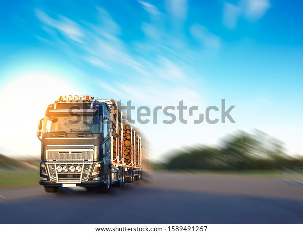 Heavy vehicle in logistics business was moving\
motion with sky blur\
background