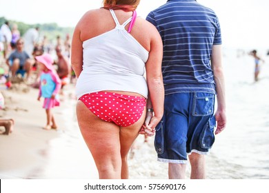 Heavy Woman Walking Hand In Hand With Boyfriend On The Beach