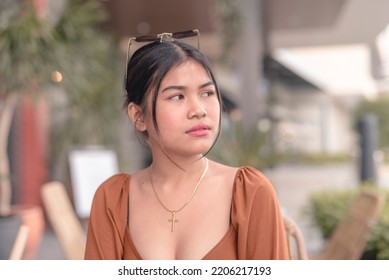 A Heavyhearted Female Teenager Sits Outside The Cafe While Contemplating About How To Solve Her Problems.