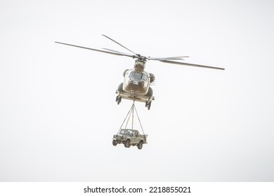 Heavy-lift Twin-helicopter Transporting A Ground Vehicle To The Combat Zone, Front View