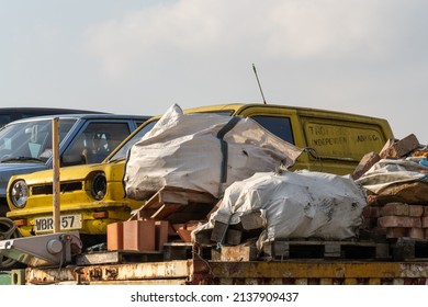 Hebburn, South Tyneside, UK - March 20th, 2022: A replica of the Trotters Independent Trading Co Reliant Regal van, from the "Only Fools and Horses" TV sitcom sits on a scrap heap awaiting recycling.