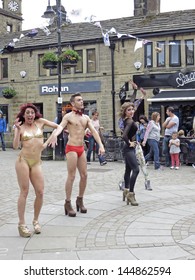 HEBDEN BRIDGE, UK - JUNE 2013: #Visitors Perform A Series Of Cheap Yet Glamorous Incidents In The Central Square Of Hebden Bridge To The Enhance Humdrum Realities  Of  Everyday Life, June 29th 2013.