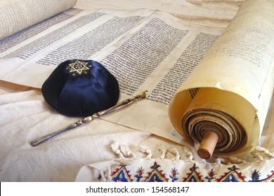 The Hebrew handwritten Torah, on a synagogue alter, with Kippah and Talith 