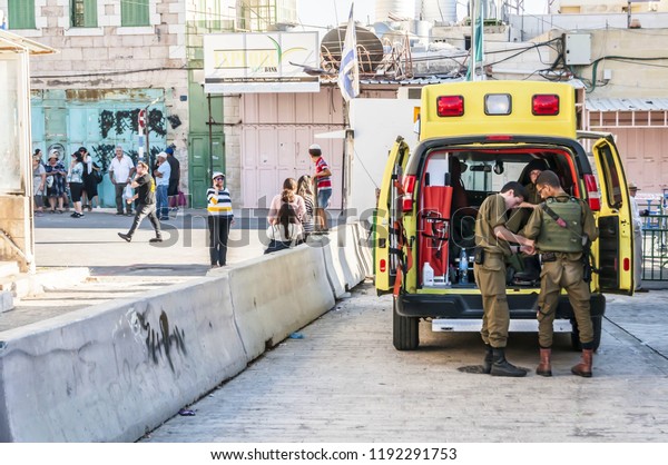 HEBRON, ISRAEL / PALESTINE. September 25, 2018.\
Ambulance emergency car with Israel army paramedics by the Cave of\
the Patriarchs in Hebron during the mass pilgrimage on the Jewish\
holiday of Sukkot.