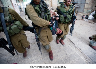 HEBRON, PALESTINIAN TERRITORY - MARCH 1: Israeli Soldiers Arrest A Palestinian Youth, Who Shows Signs Of Being Beaten, Following A Demonstration In The West Bank City Of Hebron, March 1, 2013.