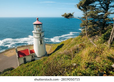 Heceta Head Lighthouse with dramatic Oregon coastline on a sunny day, Pacific Northwest, USA