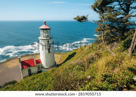 Heceta Head Lighthouse with dramatic Oregon coastline on a sunny day, Pacific Northwest, USA