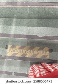 Heeding the warning: 'Watch your step'.  Especially important when you're carrying DIY supplies!