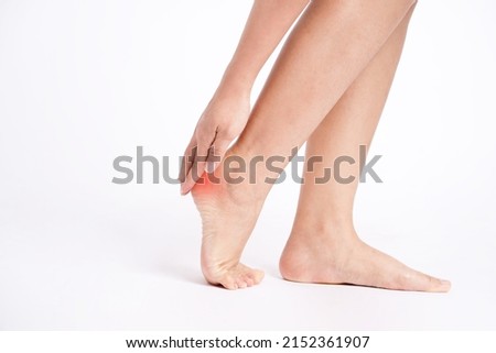 Heel pain , Heel, Hands touching heels on white background.