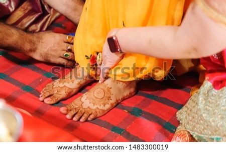 Heena Mehendi on birde feet with yellow saree at Indian Pakistani wedding ceremony