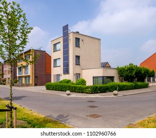 Heerhugowaard, Netherlands, May 2018. Modern, detached, two story house with vertically mounted solar panels on the facade - Shutterstock ID 1102960766