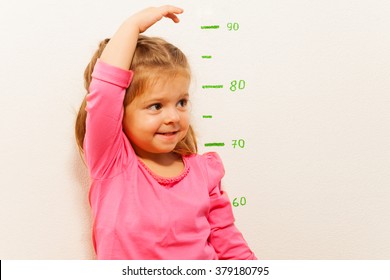 Height Measurement By Little Girl At The Wall