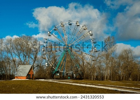 From the heights of Sigulda's Ferris wheel, winter's splendor unfolds in a panorama of sparkling snow, evergreen forests, and radiant sunlight.