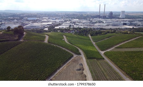 Heilbronn, Germany / Bavaria - August 18, 2020: Coal Fired Power Plant Chimney Smoke Stacks Electrical Generator With Vineyards, Cityscape, Skyline, Clouds, And View From Above. Right.