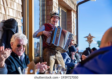 Heiligenblut, Austria - December, 2020: Tourists Enjoying Fresh Snow Of The Skiing Season And Listening To Austrian Music At The Apres Ski. In December, 2020 - Austria