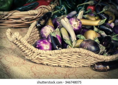 Heirloom Eggplants Of Many Colors Displayed In Giant Basket