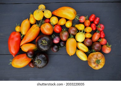 Heirloom Tomatoes Collection On Black Wooden Background. Colorful Tomatoes Vatieties.