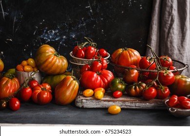 Heirloom variety tomatoes on dark rustic table text abundance ripe tomatoes - Powered by Shutterstock