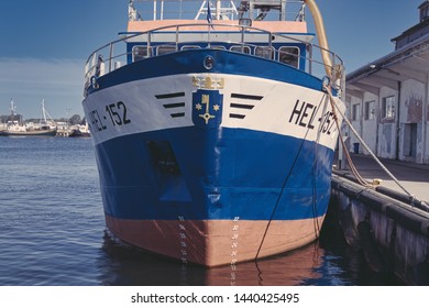 Hel, Pomorskie/Poland-06-09-2019 Fishing Vessel In The Port Of Hel, Waiting For The Exit To The Sea, Trawler Adapted To Catch Bottom Fish Using Bottom And Pelagic Trawls, On The Quay, Port Warehouses