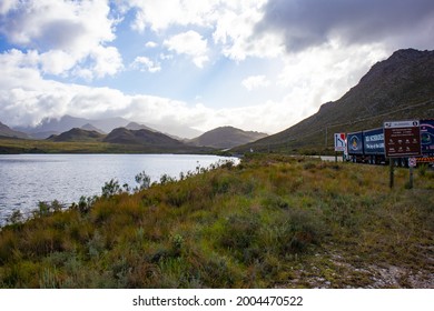 Helderberg Rural, South Africa - 26-06-2021

Long Road Next To Steenbras Dam. Surrounded By Calm Water, Grassy Mountains And Cloudy Sky.