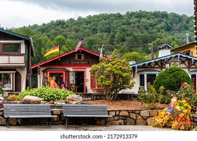 Helen, USA - October 5, 2021: Helen, Georgia Bavarian Village Restaurant Stores Shops At Oktoberfest Festival On Main Street House Buildings With German Flag And Park Bench