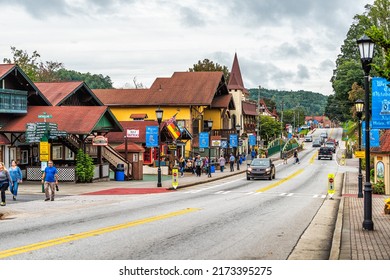 Helen, USA - October 5, 2021: Helen, Georgia Bavarian village stores shops streetscape at Oktoberfest festival with cars on main street by historic architecture buildings
