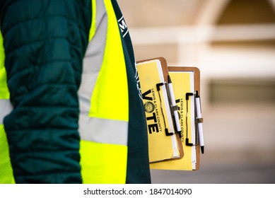 Helena, Montana / November 3, 2020: Election Official Holding Vote Ballots Waiting For Voters Outside Polling Station, Lewis And Clark County Poll Worker, Clipboard With Election Ballot Directions