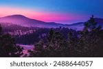 Helena Suburb Sunrise Skyline over the Helena National Forest and Avalanche Butte in Montana, USA: Tranquil mountain valley summer landscape with pink sky