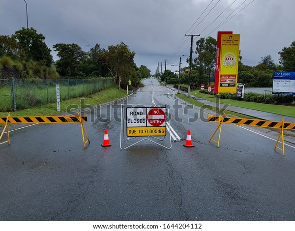 Helensvale, Queensland / Australia - February 13th
2020:
Helensvale Flooding - Siganto Drive Road Closure Debris with
Road Closure Sign