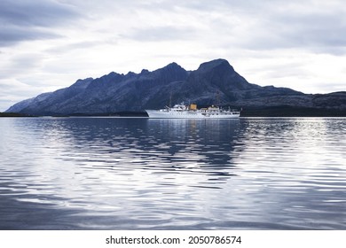 Helgeland, Norway - August 9, 2021.The Norwegian Royal Yacht "Norge", with Syv Søstre mountains on the background.