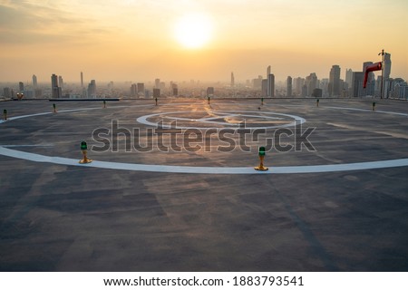 The Heli Copter parking lot on the deck at sunset in the capital of Thailand. Space for helicopter landing on high-rise buildings in Bangkok, Thailand.