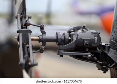 Helicopter Blades And Propeller Mechanism On A Helicopter. Gears And Drives For The Propeller Blades On The Tail End Of A Helicopter Very Up Close, Outside Of The Hanger At An Airport.