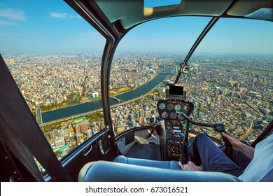 Helicopter Cockpit Inside The Cabin Flying On Tokyo City Skyline, Sumida River Bridges And Asakusa Area. Daytime. Tokyo, Japan.